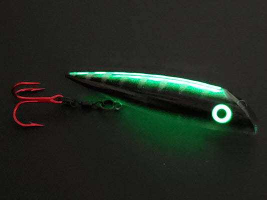 FishGunn Salmon Plug 'Black Racer' by Fisher Tackle in dark showing just spine, eyes and belly glowing...black body sides are blocking glow