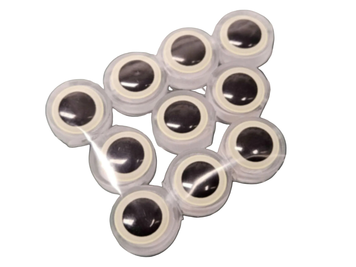 10-pack of BigEye Trolling Fly Beads for salmon and trout. Feature large glow eyes, translucent UV resin body, and line thru-hole shown on a green work mat.