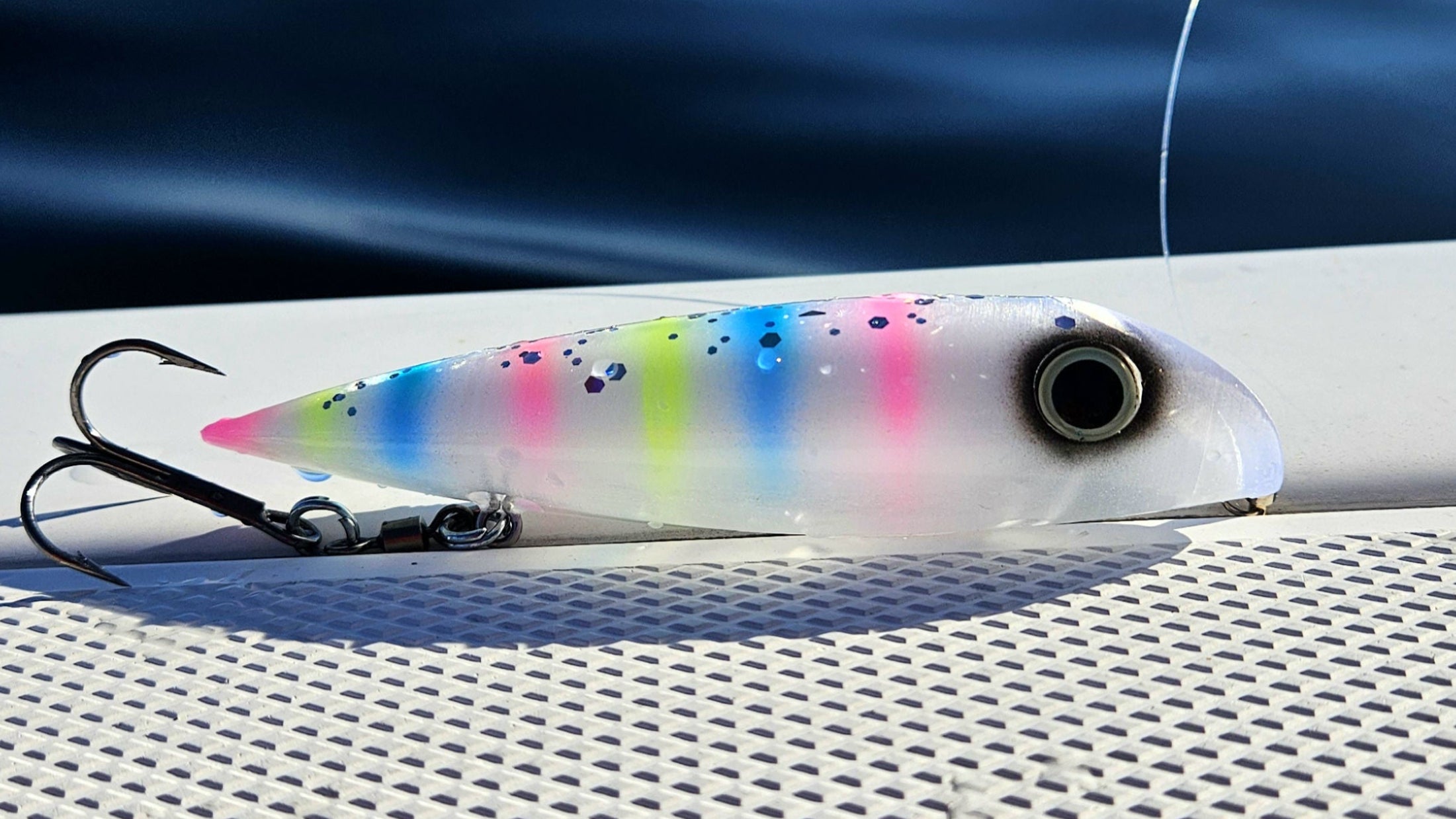 Fishgunn salmon plug on boat deck with lake michigan in background