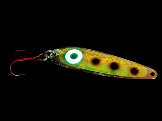 Salmon spoon with a green body and black spots on a black background with glowing ring eye