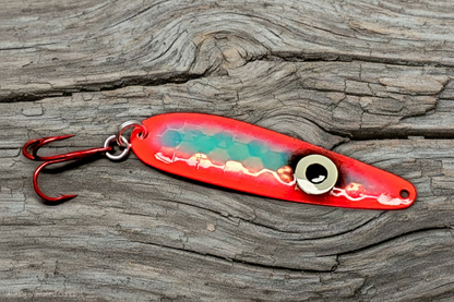 Fisher Tackle 'SeeingRed' trolling spoon with large ring eye and hot red sides on weathered wood background