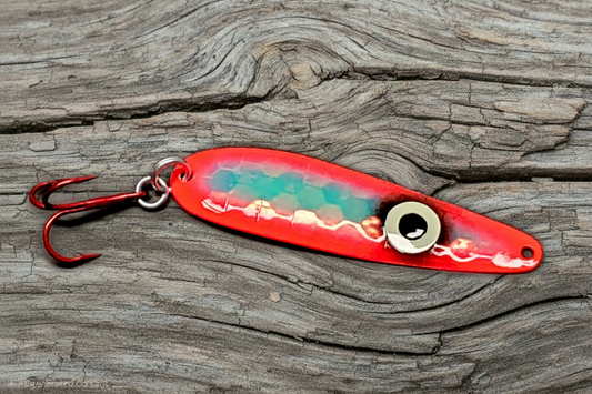 Fisher Tackle 'SeeingRed' trolling spoon with large ring eye and hot red sides on weathered wood background
