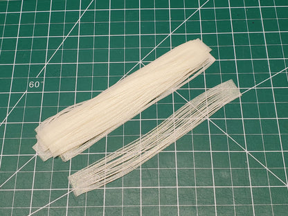 10pcs of Green glow silicone skirt tabs on work mat in daylight
