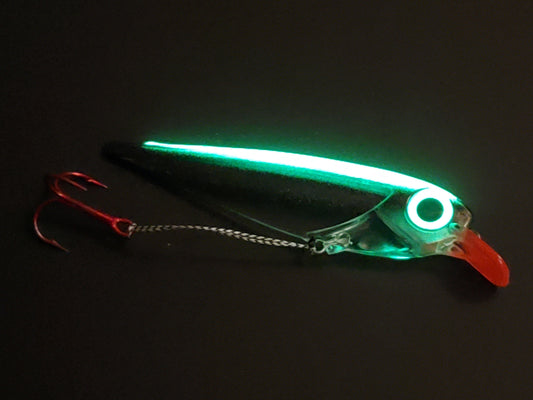 Black Striped FlatFin Trolling Lure with Red Lip and Large Glow Eye inglowing on dark background