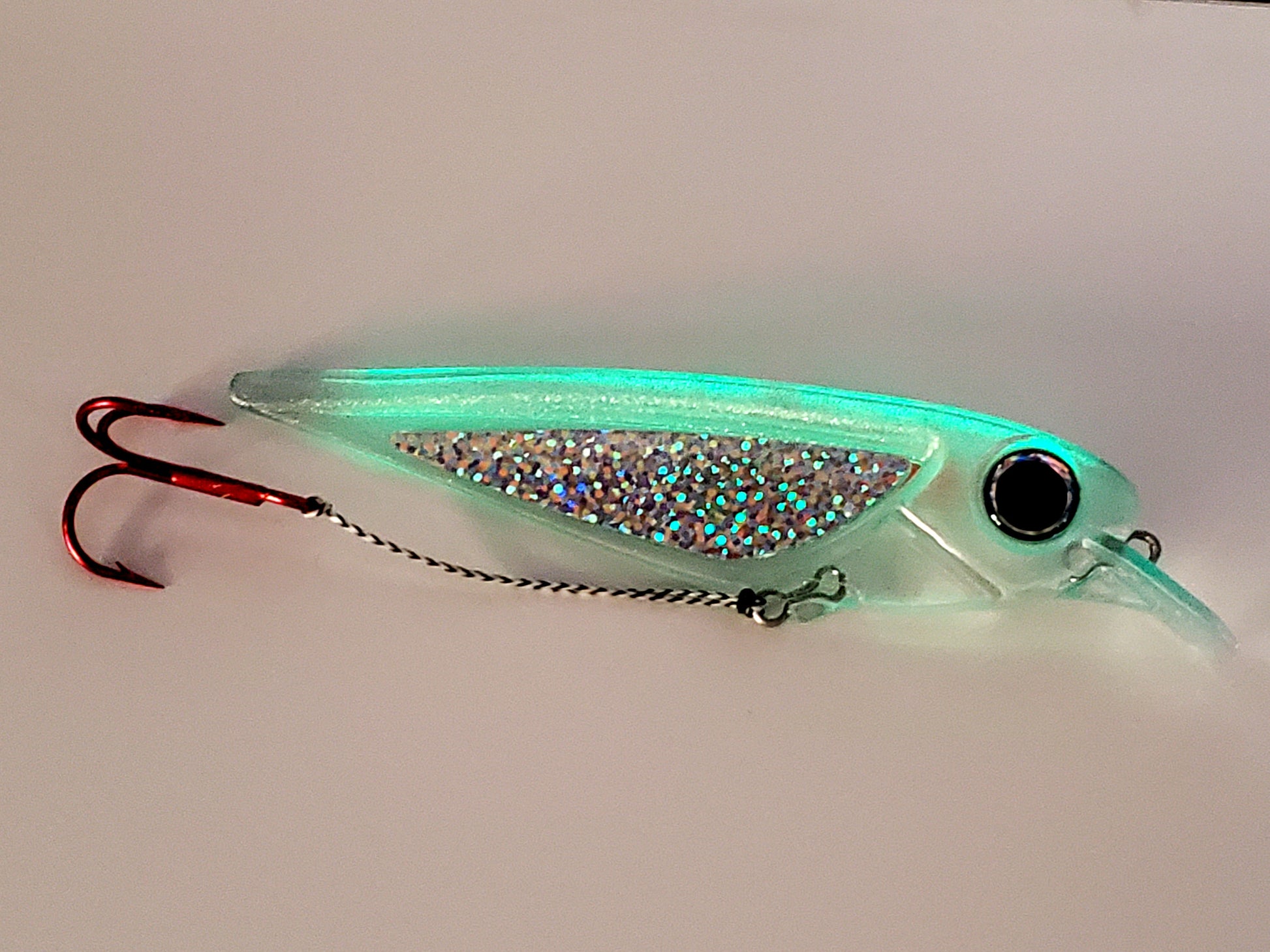FlatFin 'FlashBang' trolling minnow glowing with holographic sides and huge pearl blue eye