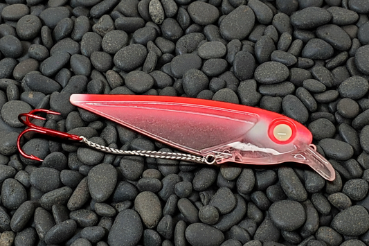 FlatFin Minnow Hot Red 'Inverto' lure on dark pebble background