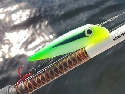 Lime Hornet green and yellow and black salmon plug on a fishing rod with water in the background
