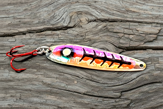 Fisher Tackle Super Glow Magma Spoon on weathered wood background