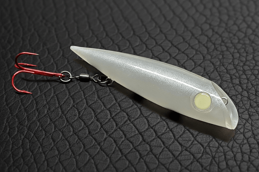 Pearl Salmon Plug with all glow eye on scaled black leather background