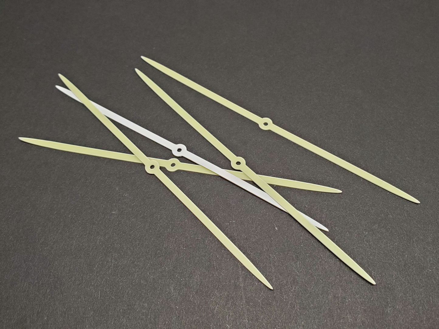 5 salmon trolling fly glow strips in daylight on dark gray background