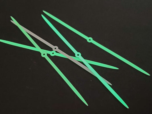 5 salmon fly glow strips glowing on black background