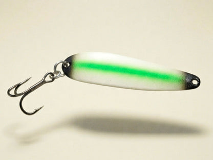 Green with black tips glow trolling spoon floating above white background
