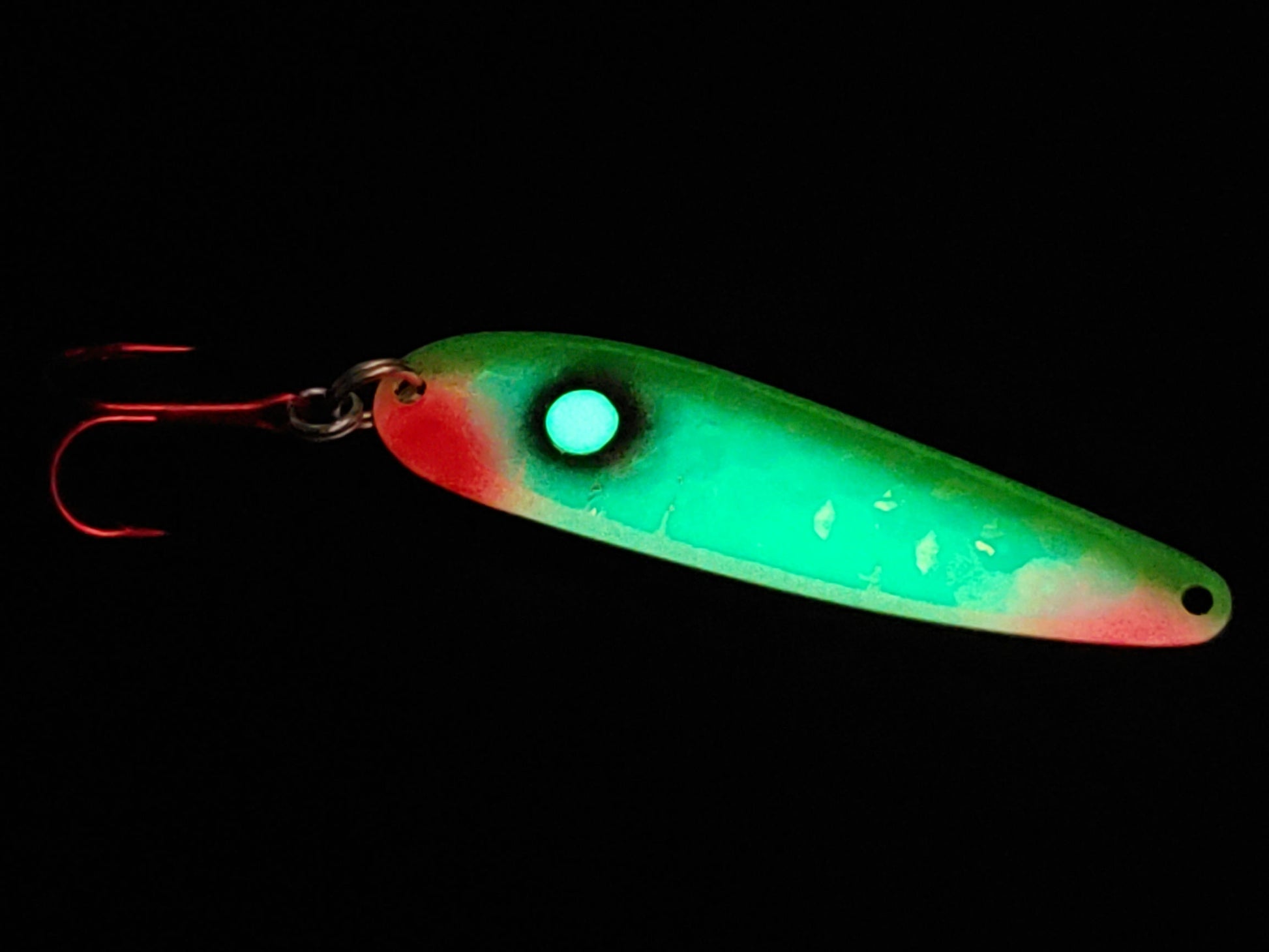green pink and red glowing trolling spoon in dark