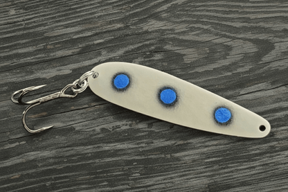 Fisher Tackle UltraMega Glow 'BlueEyes' salmon trolling spoon with blue glow base and 3 large fluorescent blue dots fringed in black in daylight