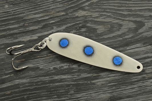 Fisher Tackle UltraMega Glow 'BlueEyes' salmon trolling spoon with blue glow base and 3 large fluorescent blue dots fringed in black in daylight