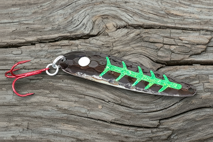 Certain Death spoon on weathered wood background
