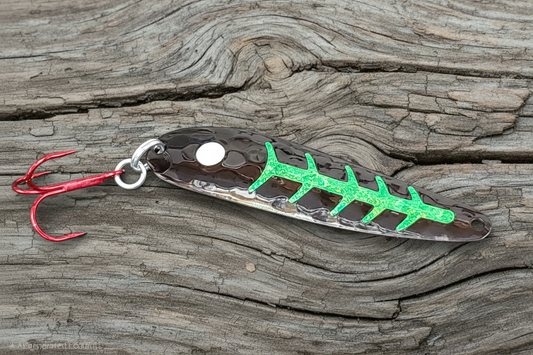 Certain Death spoon on weathered wood background