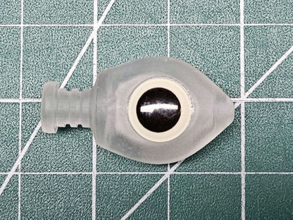 Close-up of BigEye FLOATING Trolling Fly Head with a large glow eye and keeper collar on a green work mat.