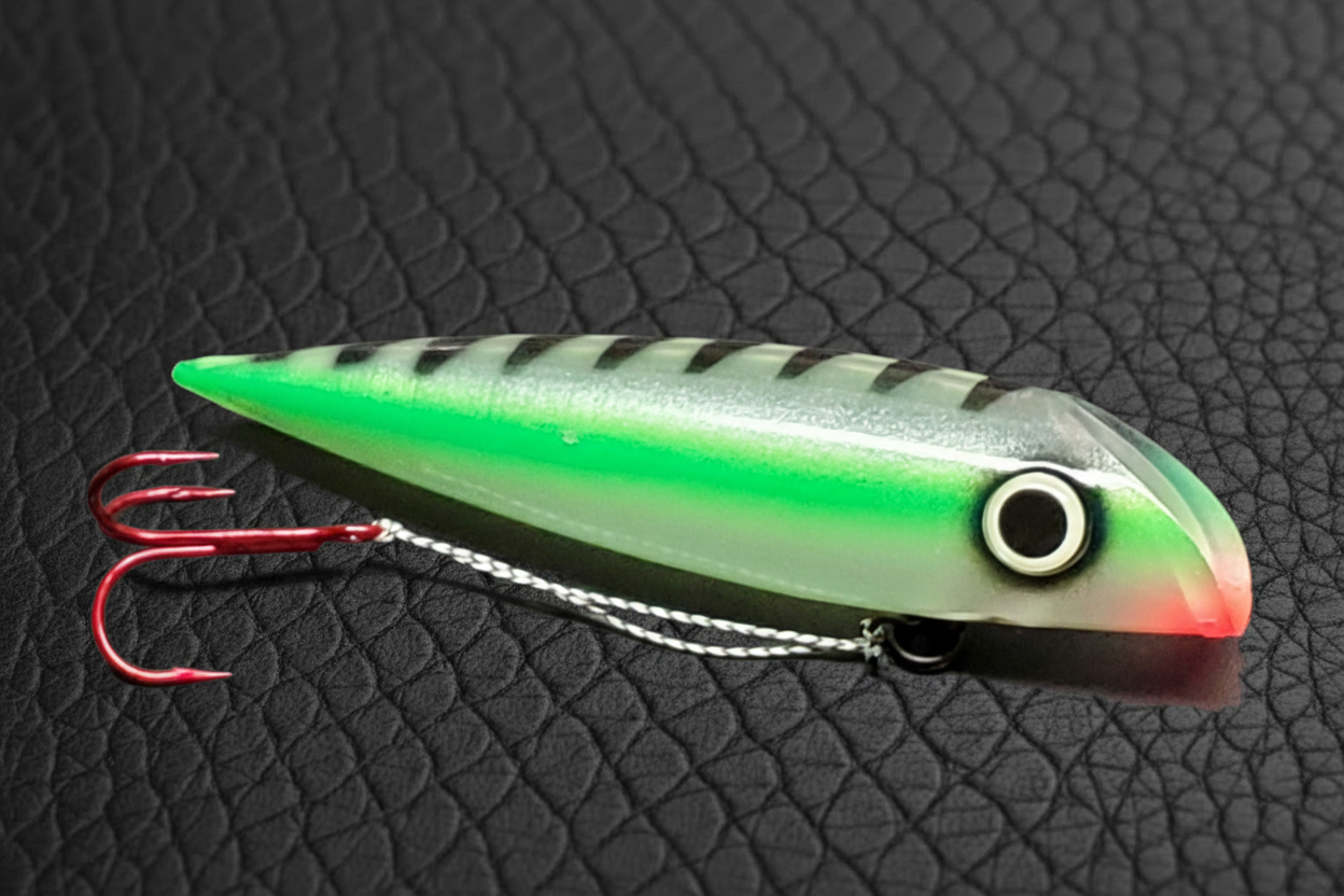 Green striped spoon on black scales