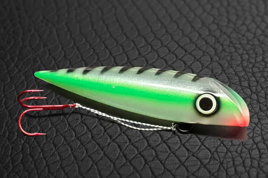 Green striped spoon on black scales