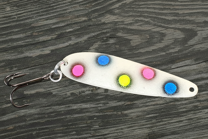 Fisher Tackle UltraMega Glow BlueBread salmon trolling spoon with blue glow base, fluorescent blue, pink, and yellow dots fringed in black in daylight