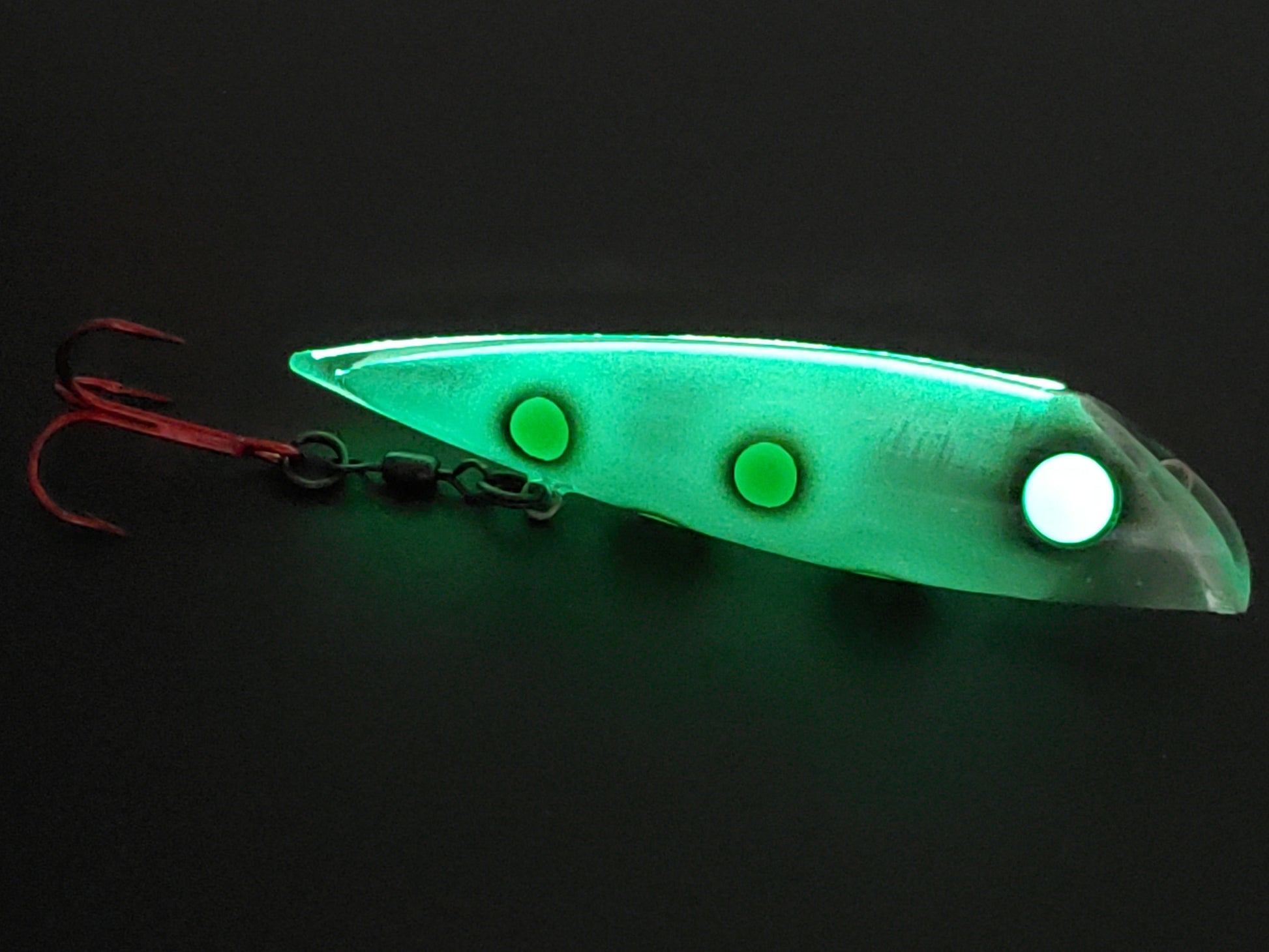 LIVING DEAD FROG FishGunn salmon trolling plug by Fisher Tackle glowing in dark as glow spine transmits through the translucent body and frog-like green dots.  large pupil-less creepy glow eye too