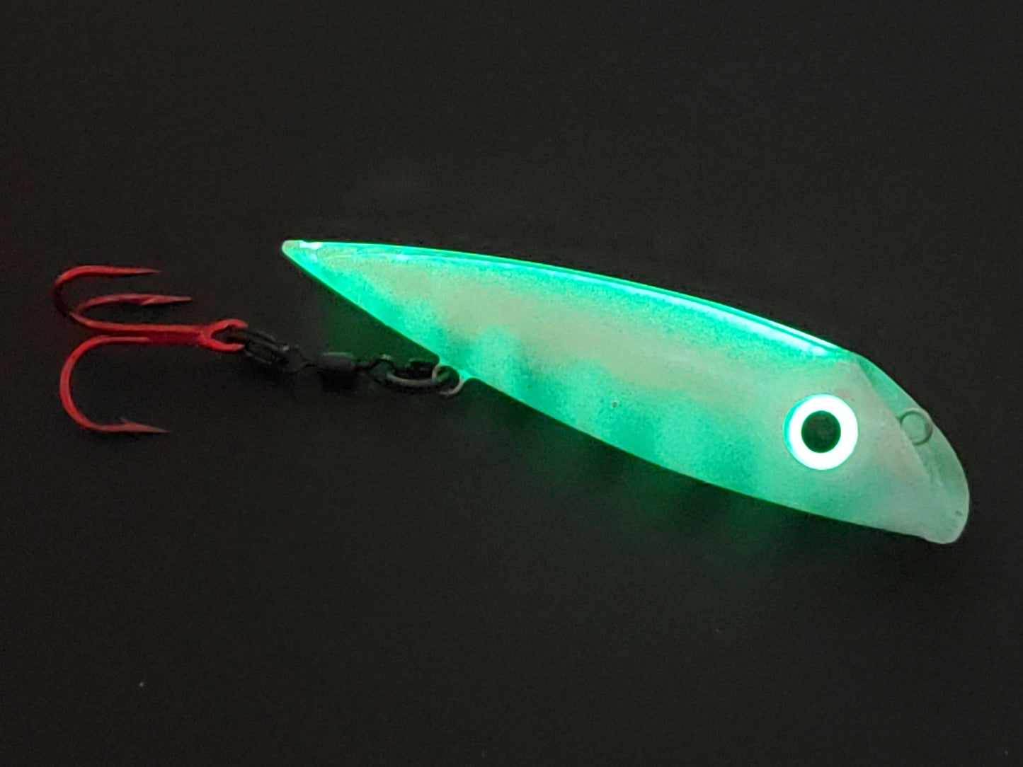 Made for salmon trolling the FishGunn Salmon Plug 'WhiteWasp' glowing from whole body with just spine and eye charged with UV