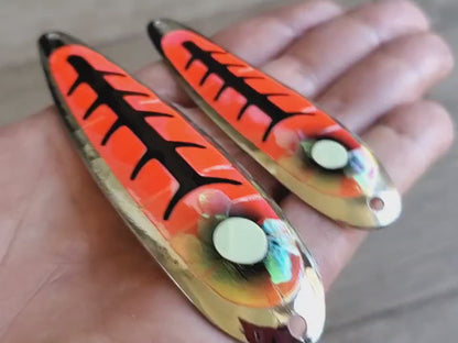 Video of MAGMA orange and red holographic with black accents salmon trolling spoons