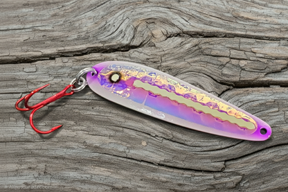 Purple Zit Ripper spoon on weathered wood background