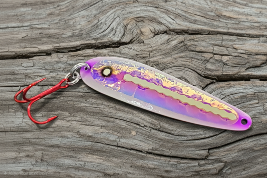 Purple Zit Ripper spoon on weathered wood background
