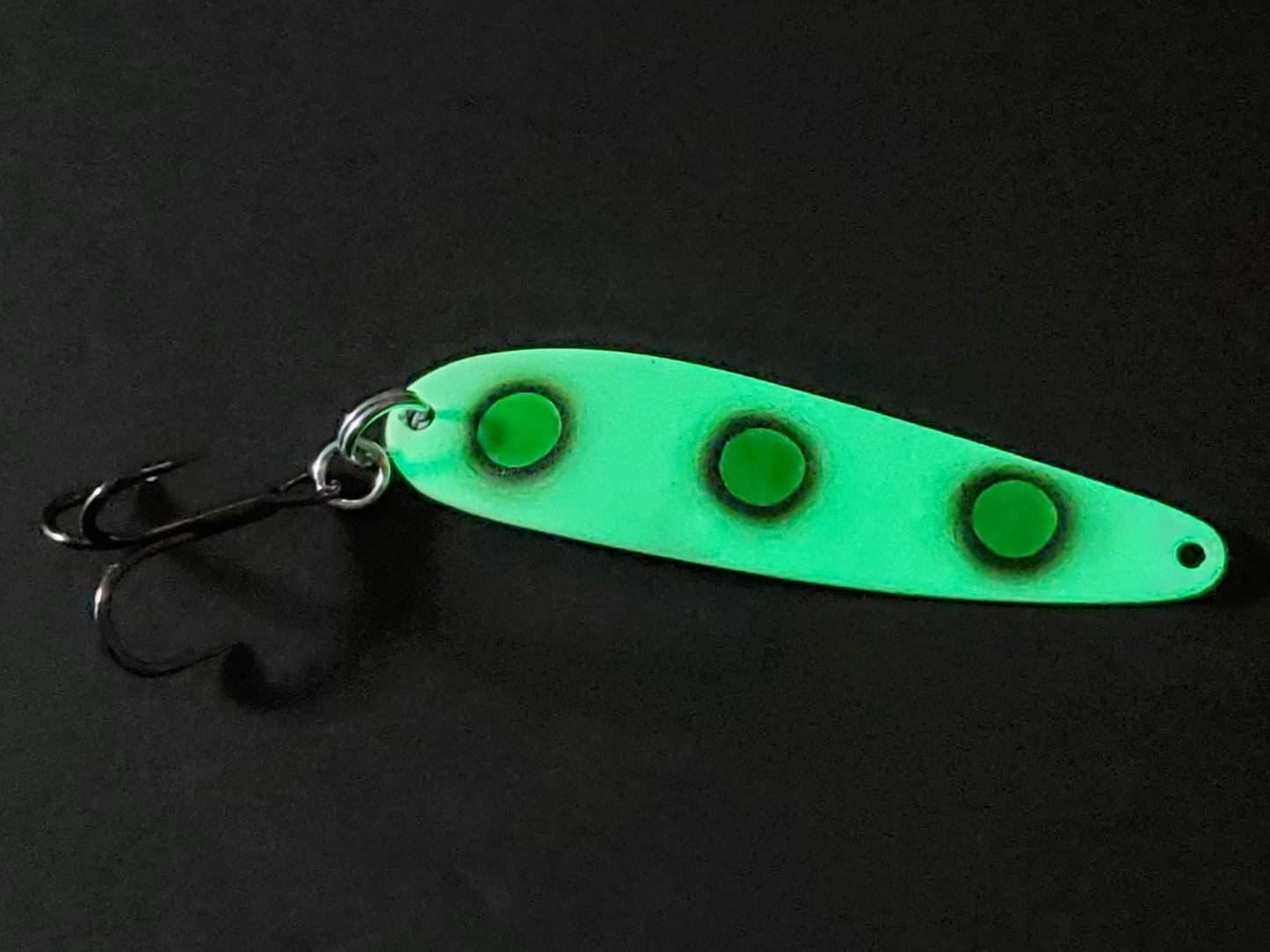 Fisher Tackle UltraMega Glow Green Eyes salmon trolling spoon with green glow base, green spots fringed in black glowing in dark