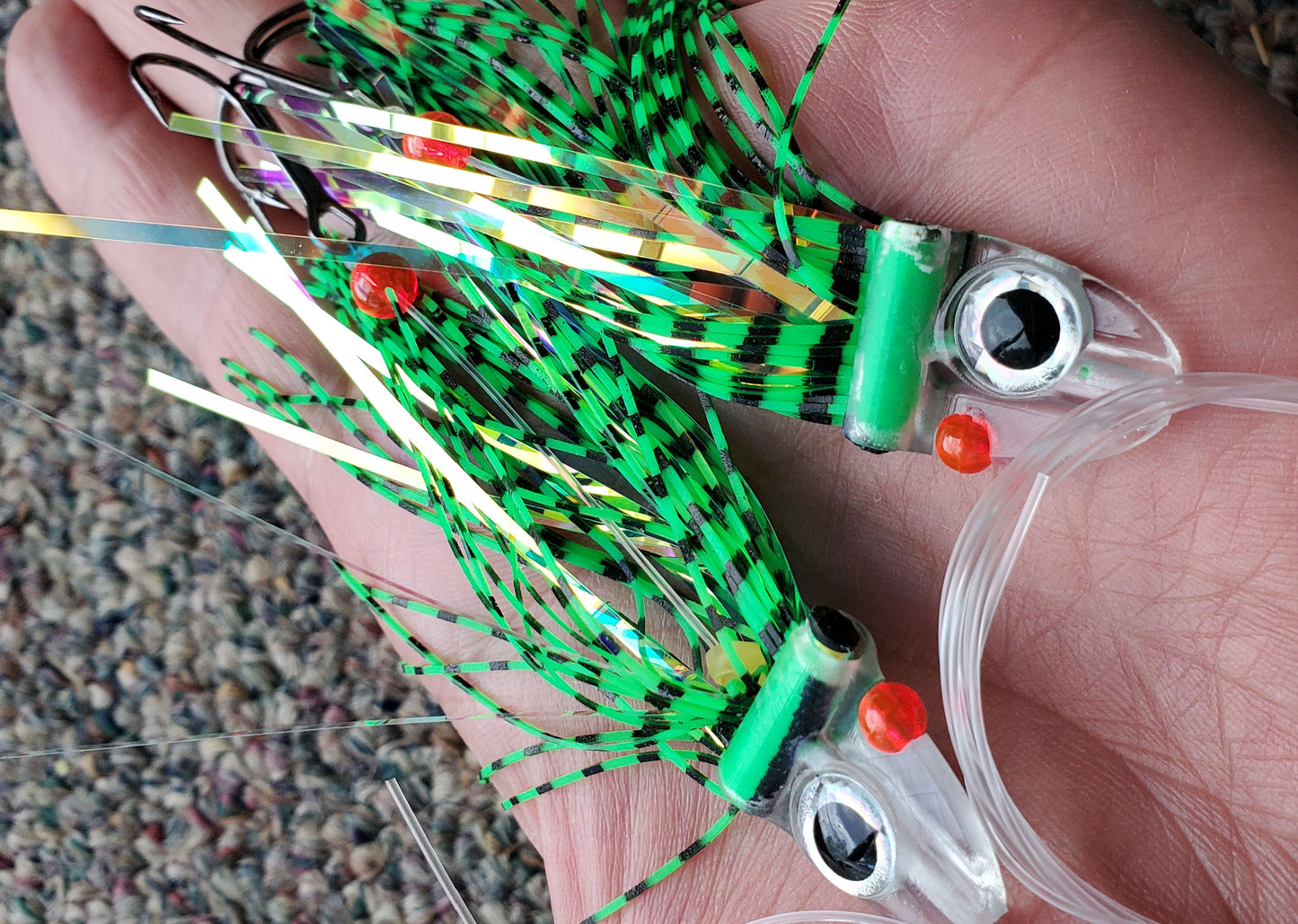 Tiger Green FlatHead Trolling Flies - 2pcs - in palm of hand Fisher Tackle Company