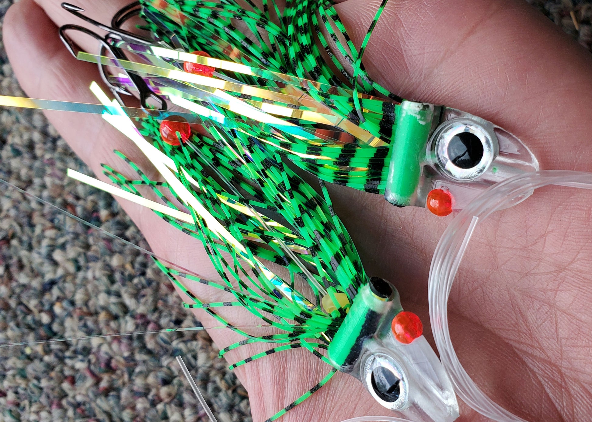 Tiger Green FlatHead Trolling Flies - 2pcs - in palm of hand Fisher Tackle Company