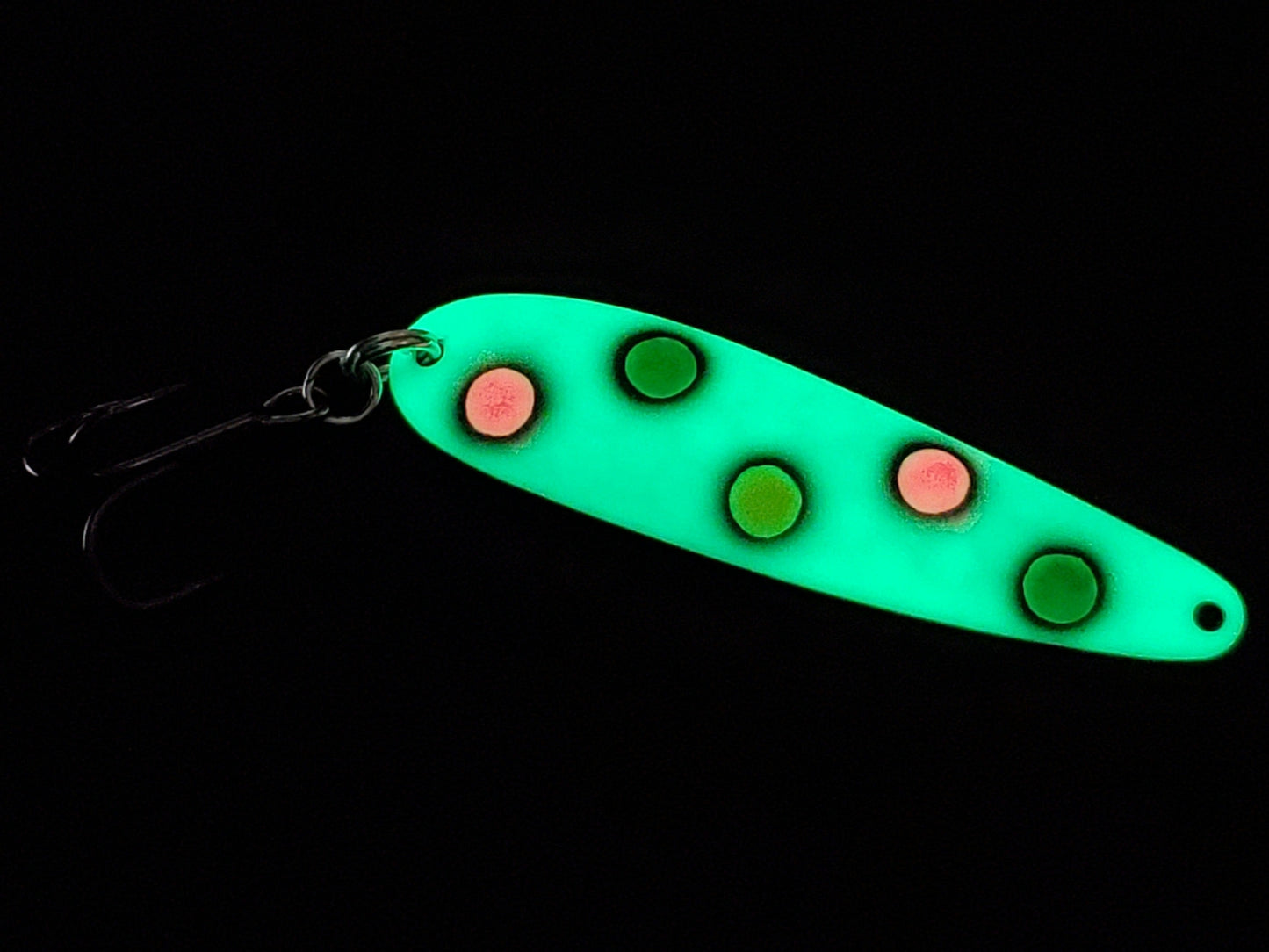 Fisher Tackle UltraMega Glow GreenBread salmon trolling spoon with green glow base, green, pink and yellow spots fringed in black glowing in dark