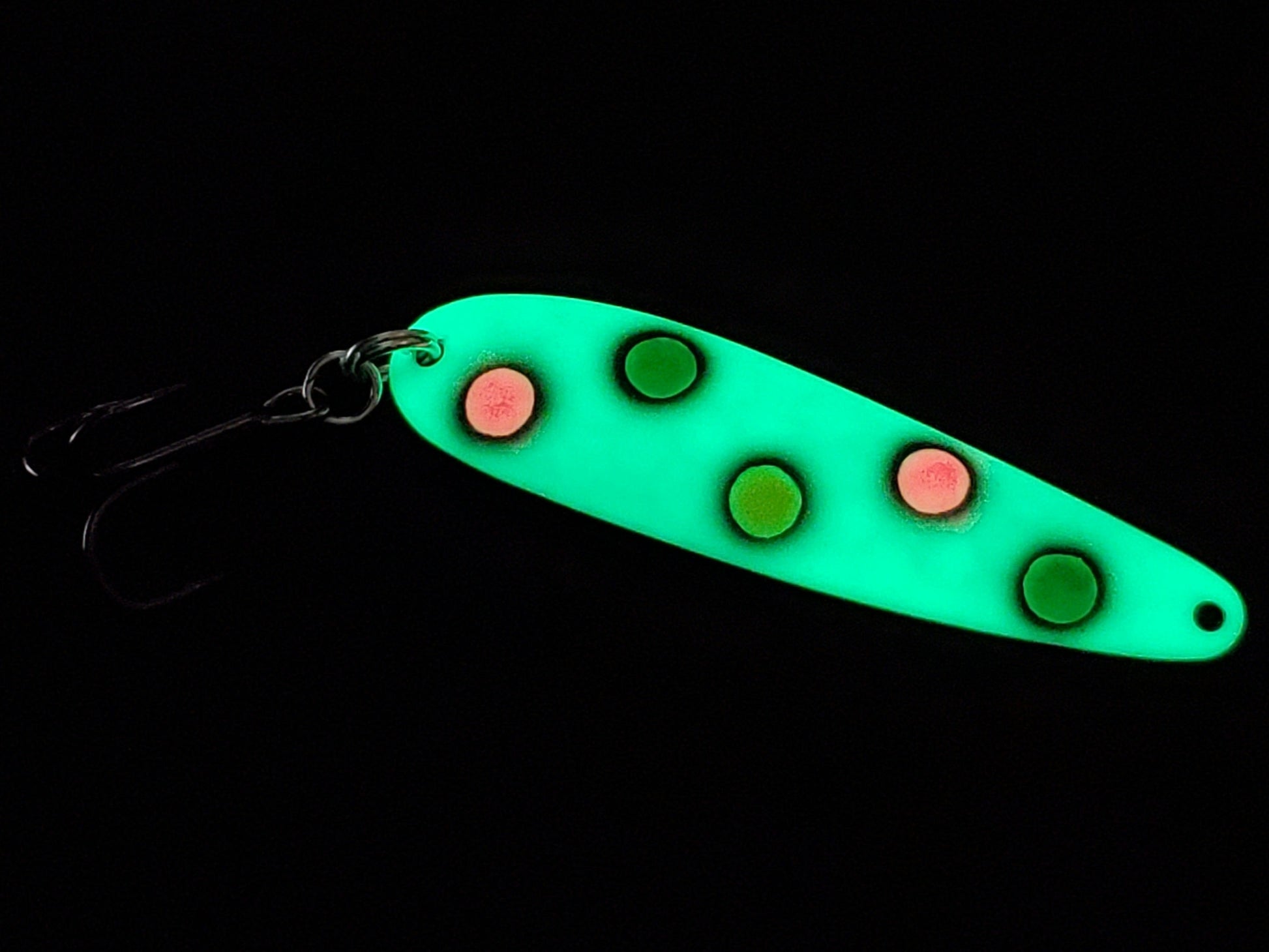 Fisher Tackle UltraMega Glow GreenBread salmon trolling spoon with green glow base, green, pink and yellow spots fringed in black glowing in dark