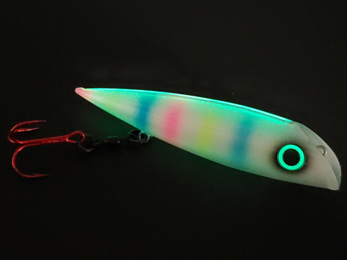 Trolling lure FishGunn Salmon Plug 'Tizzy Fit' glowing in dark showing lures pearlescent white glitter sides, large glow eye with pink/blue/yellow tiger stripes showing thru