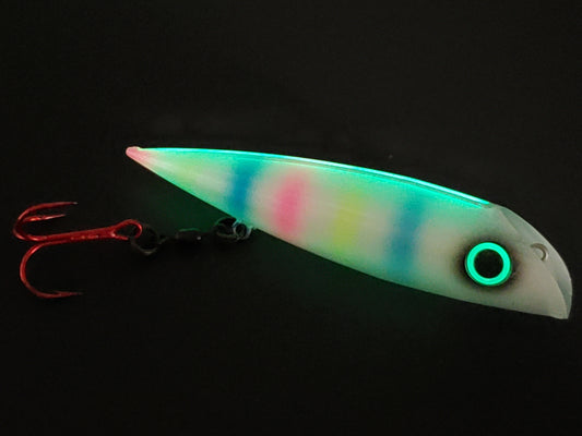Trolling lure FishGunn Salmon Plug 'Tizzy Fit' glowing in dark showing lures pearlescent white glitter sides, large glow eye with pink/blue/yellow tiger stripes showing thru