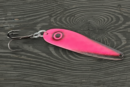 Fisher Tackle UltraMega Glow 'Screaming Puck Bunny' salmon trolling spoon with Hot Pink glow base, black tips and eye in daylight